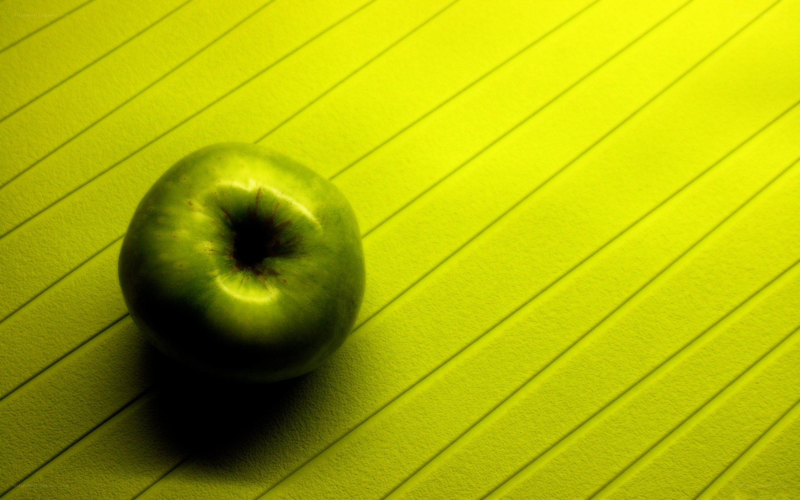 green apple on lined surface