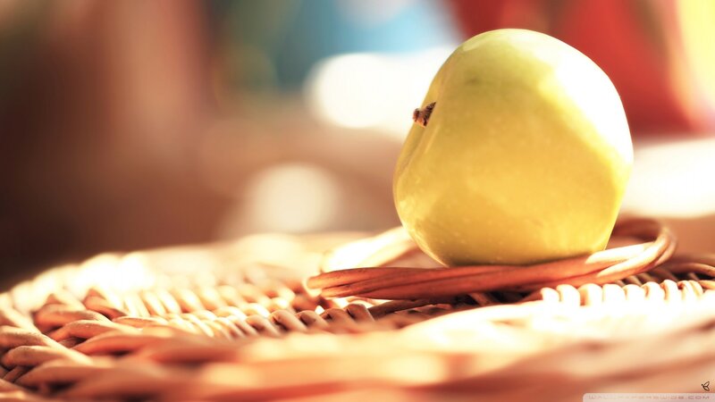green apple on woven basket