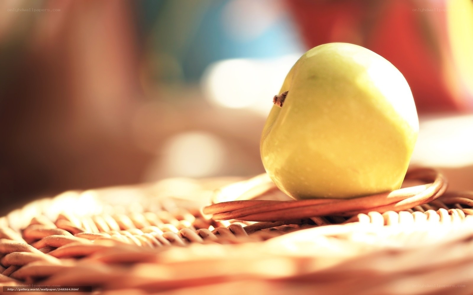 green apple on woven basket