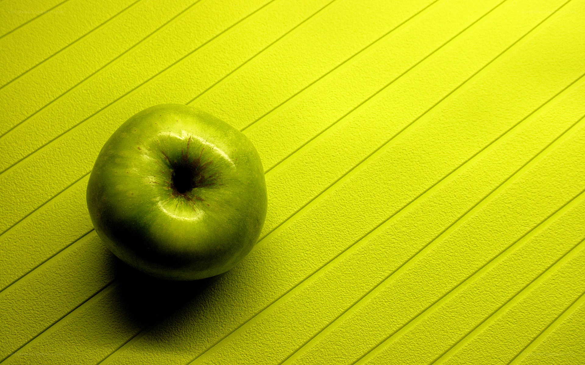 green apple on yellow surface