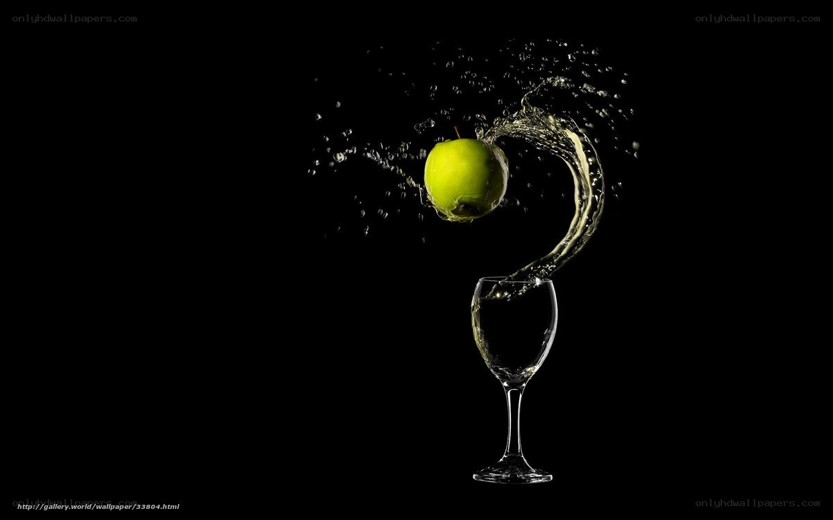 green apple splashing into wine glass