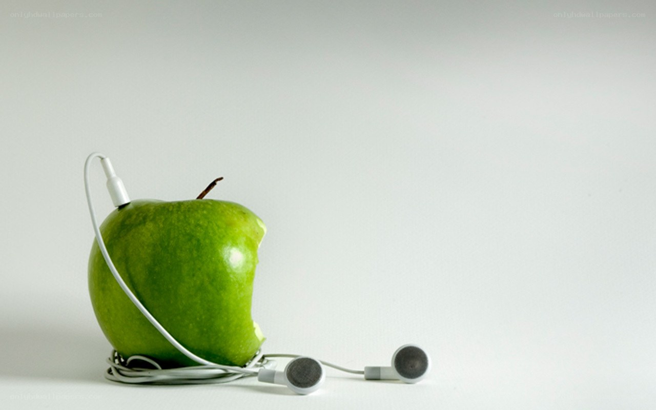 green apple with earbuds