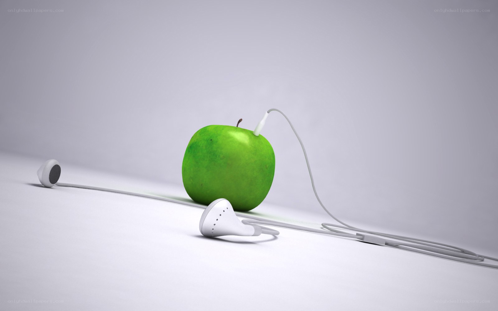 green apple with earbuds