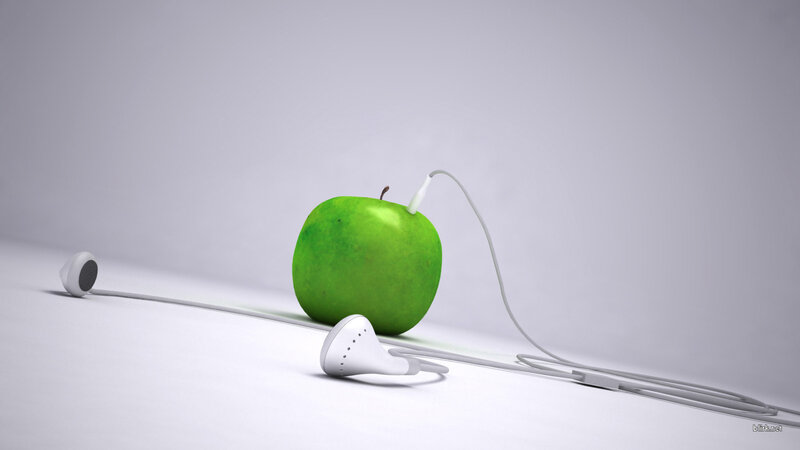 green apple with earbuds