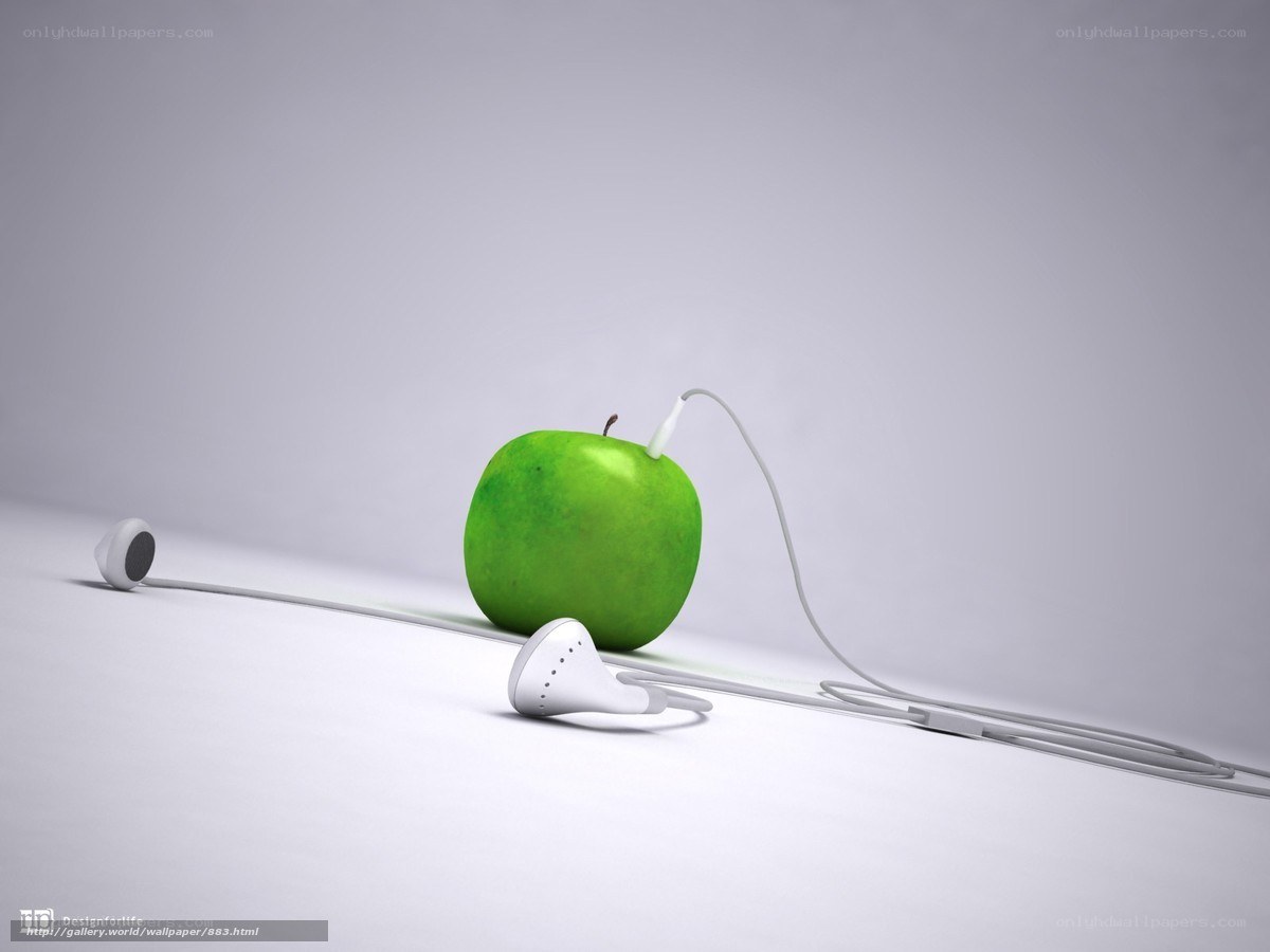 green apple with earbuds