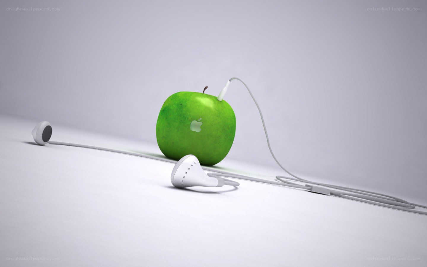 green apple with earphones