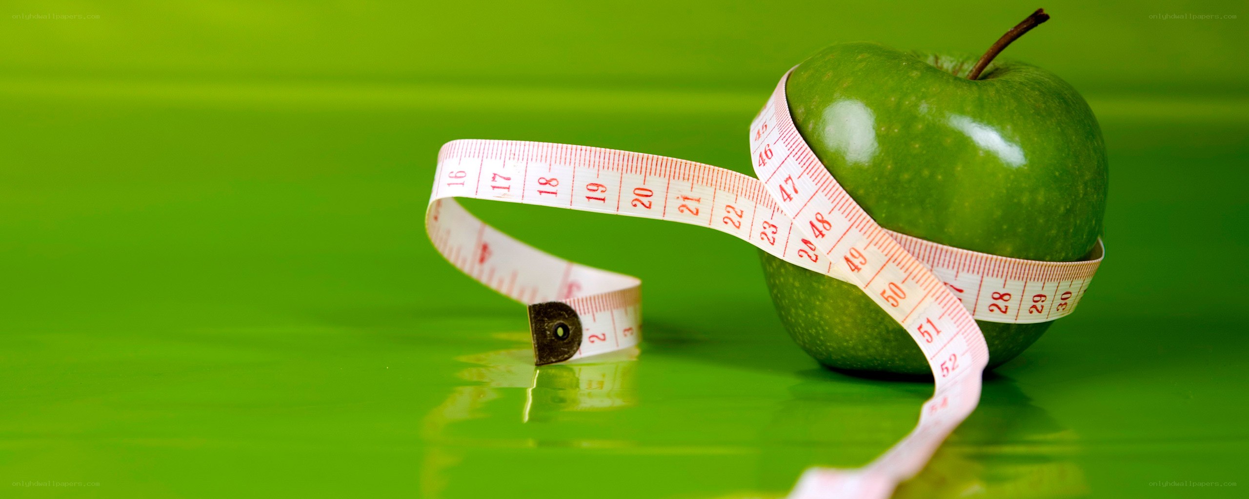 green apple with measuring tape