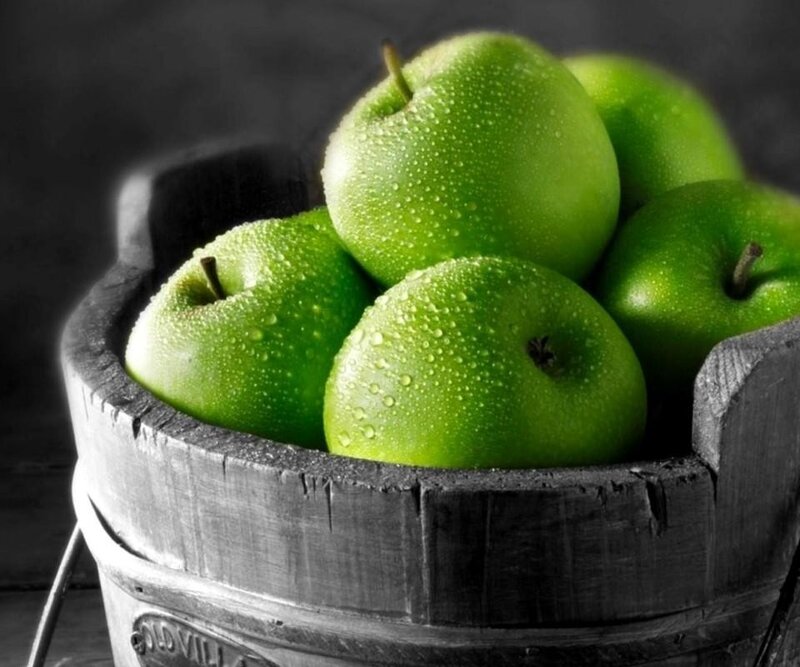 green apples in a wooden bucket