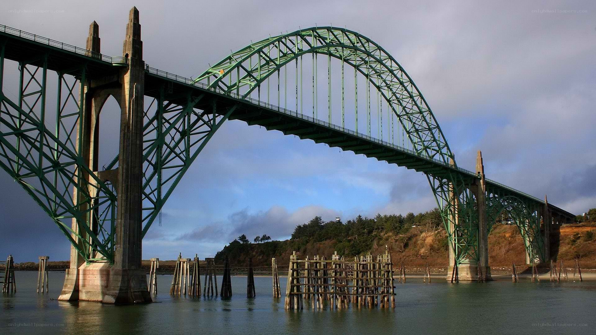 Green arch bridge over water