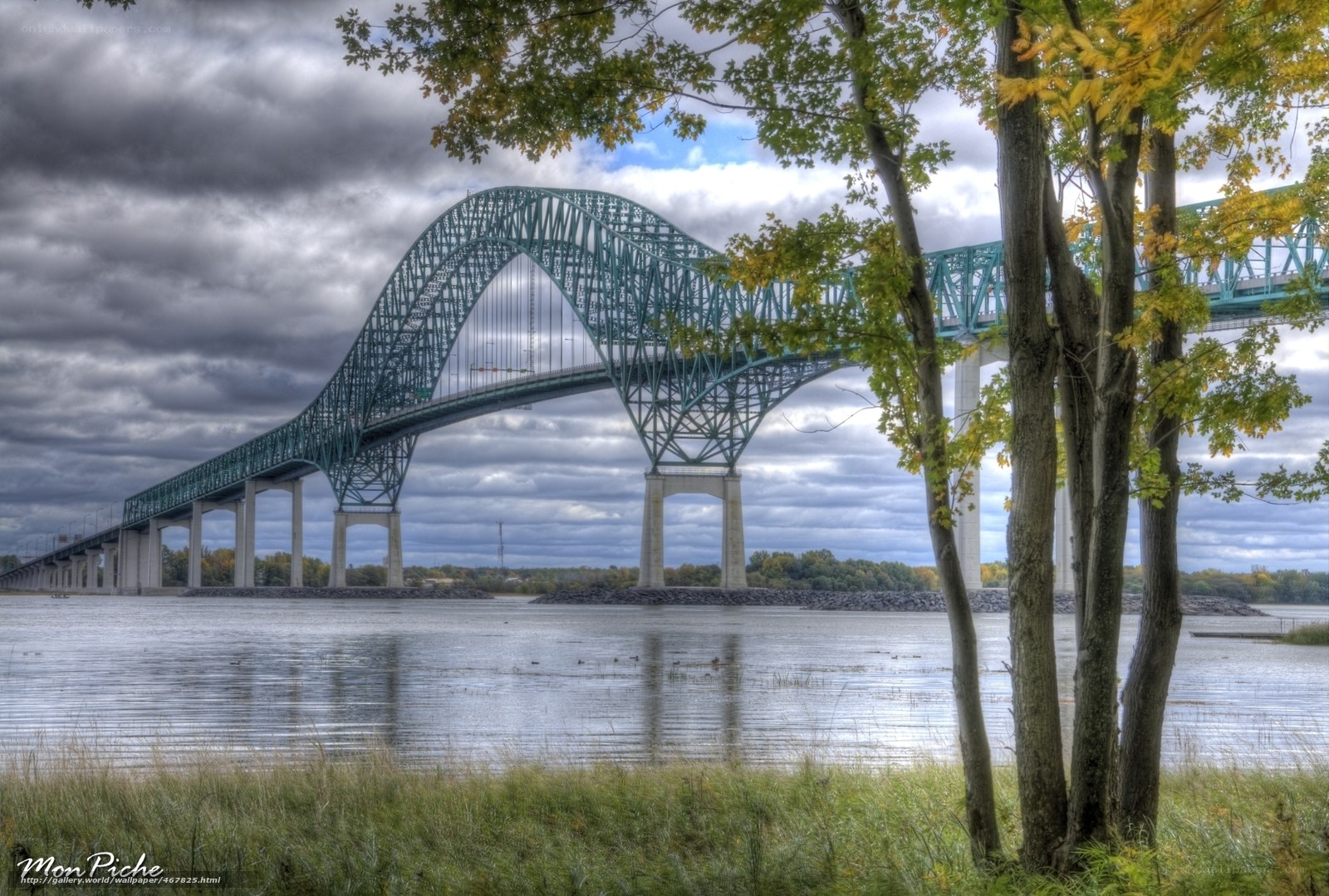 Green arch bridge over water