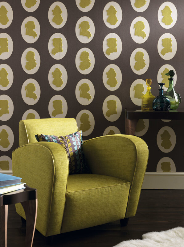 Green armchair with patterned wallpaper