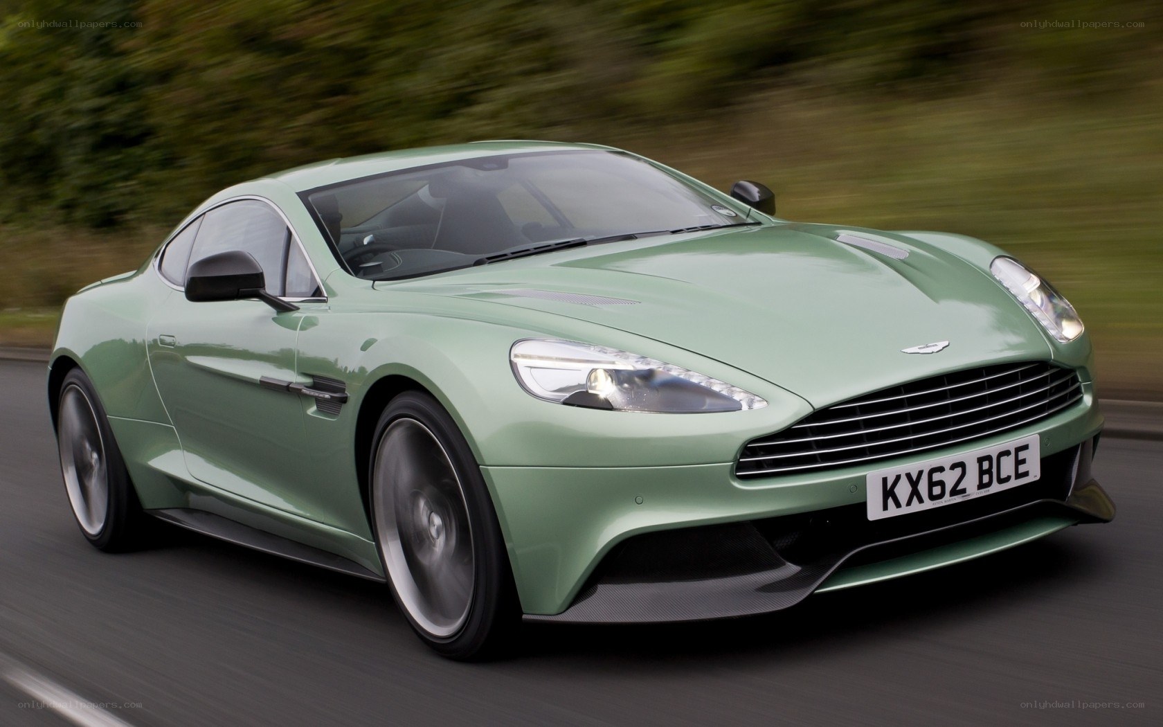 green aston martin driving