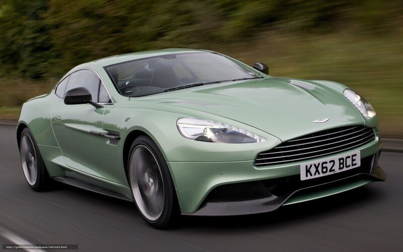 green aston martin in motion