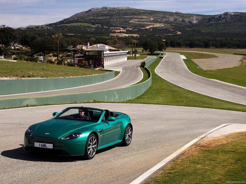 Green Aston Martin on a racetrack