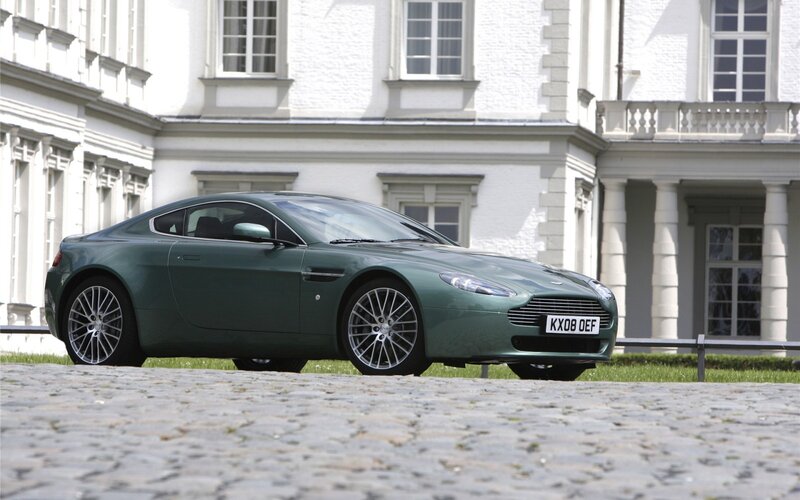 Green Aston Martin on cobblestones