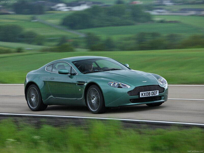 green aston martin on country road