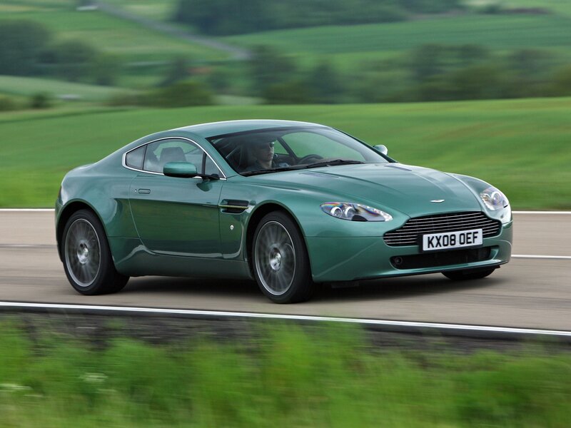 Green Aston Martin on country road