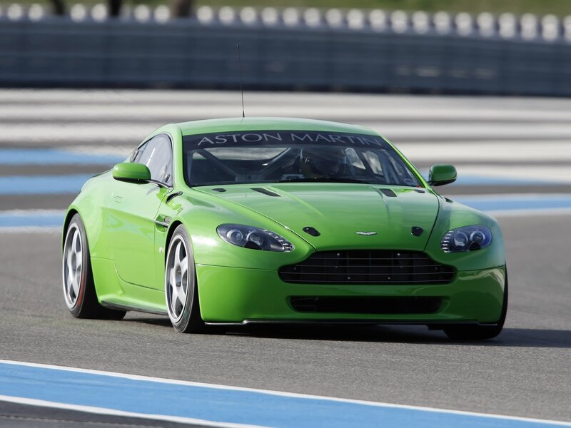 Green Aston Martin on racetrack