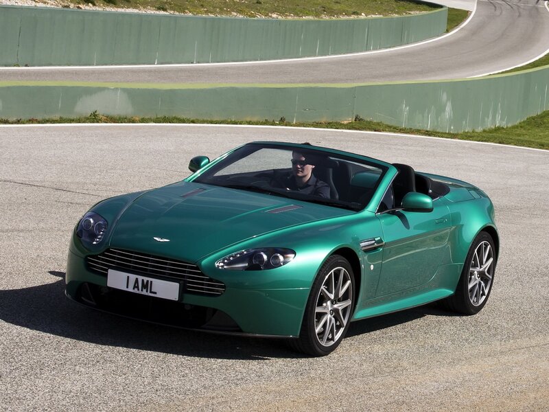 Green Aston Martin on racetrack