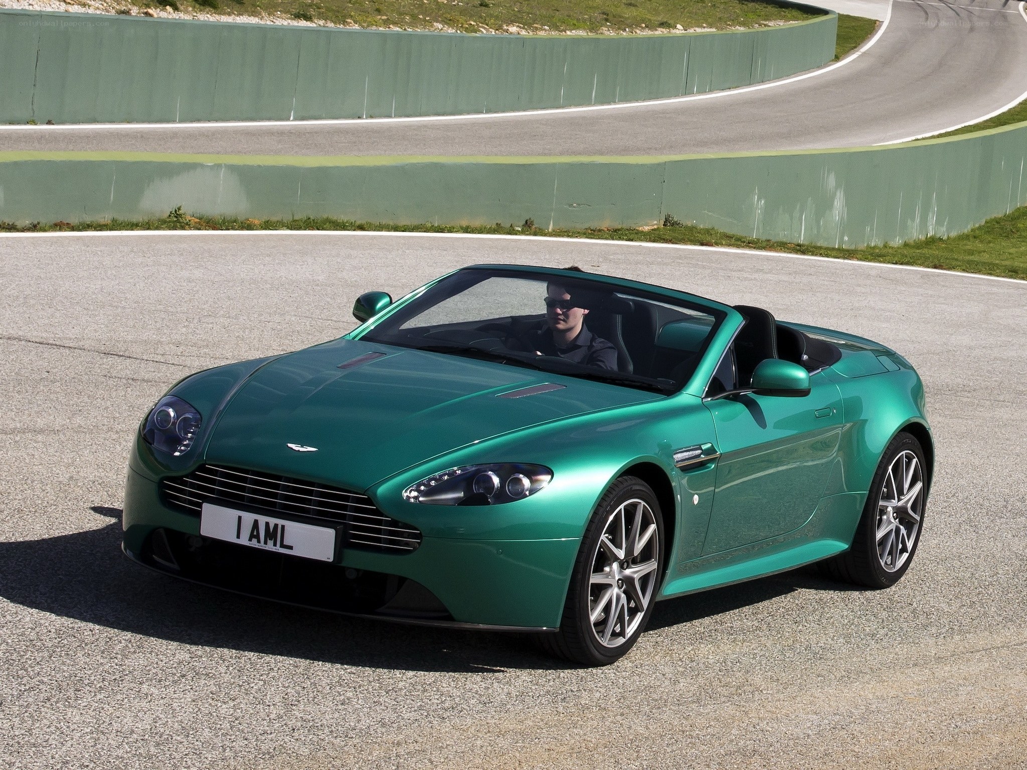Green Aston Martin on racetrack