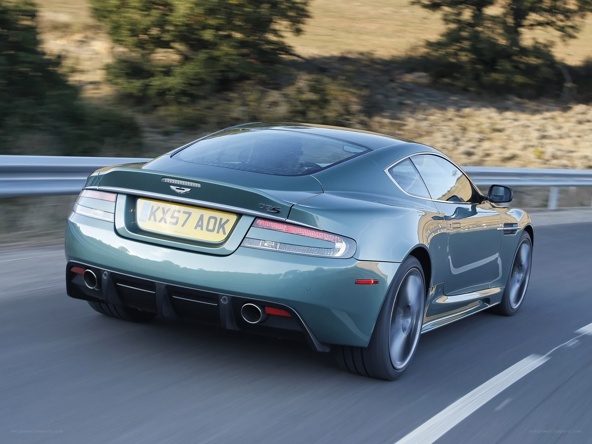 green aston martin on road