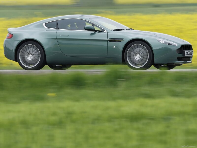 green aston martin on road