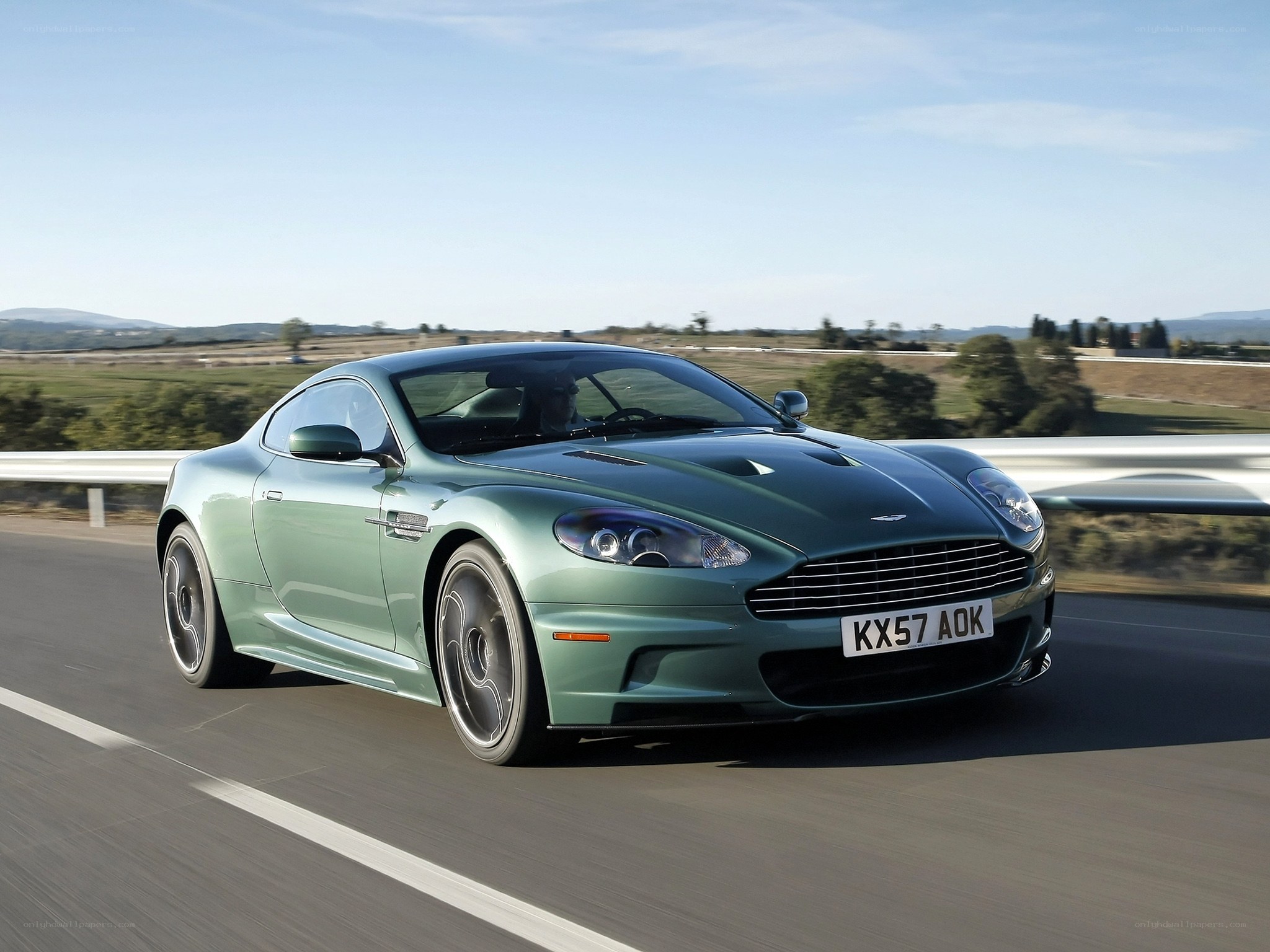 green aston martin on road