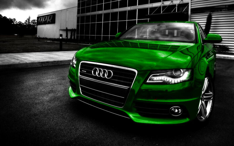 green audi car in front of building