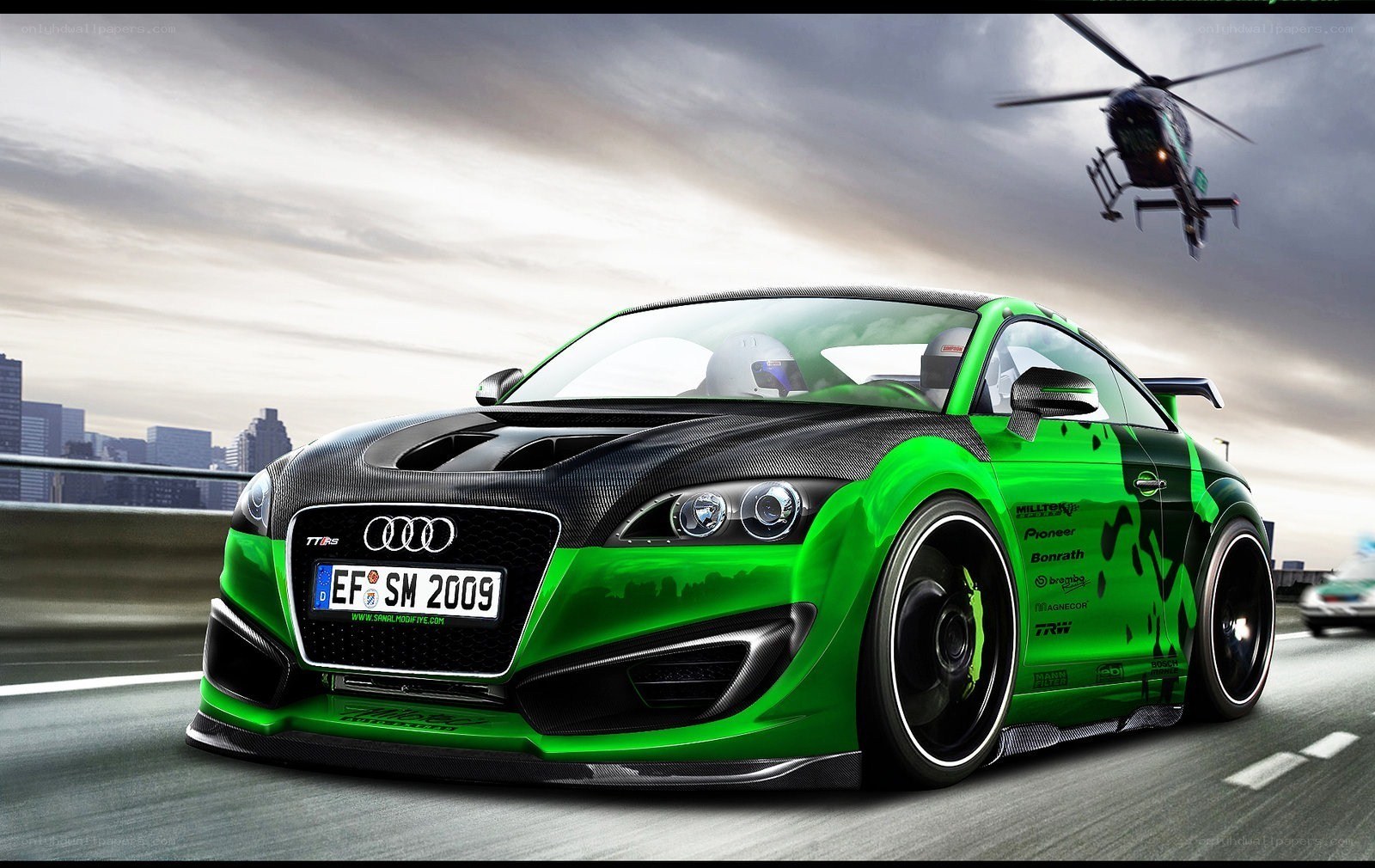 green audi on city highway