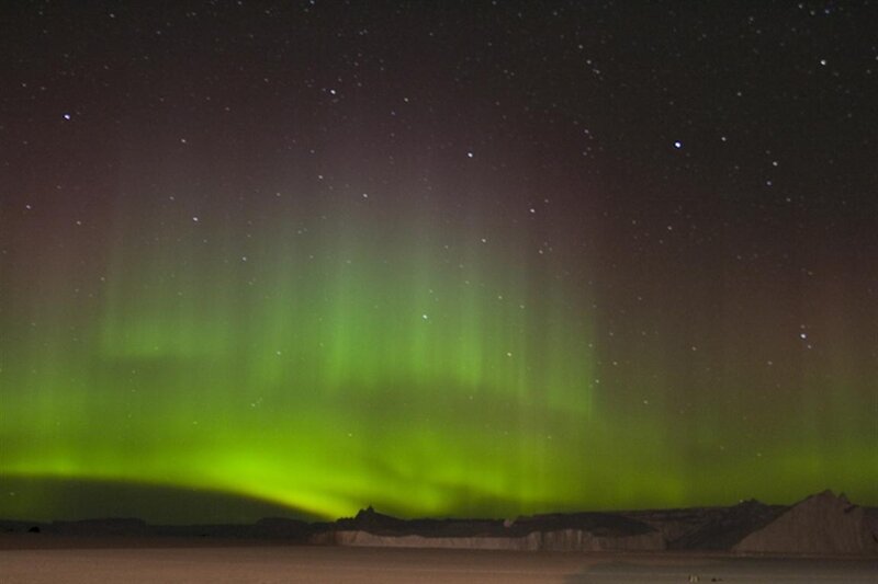 Green aurora borealis at night