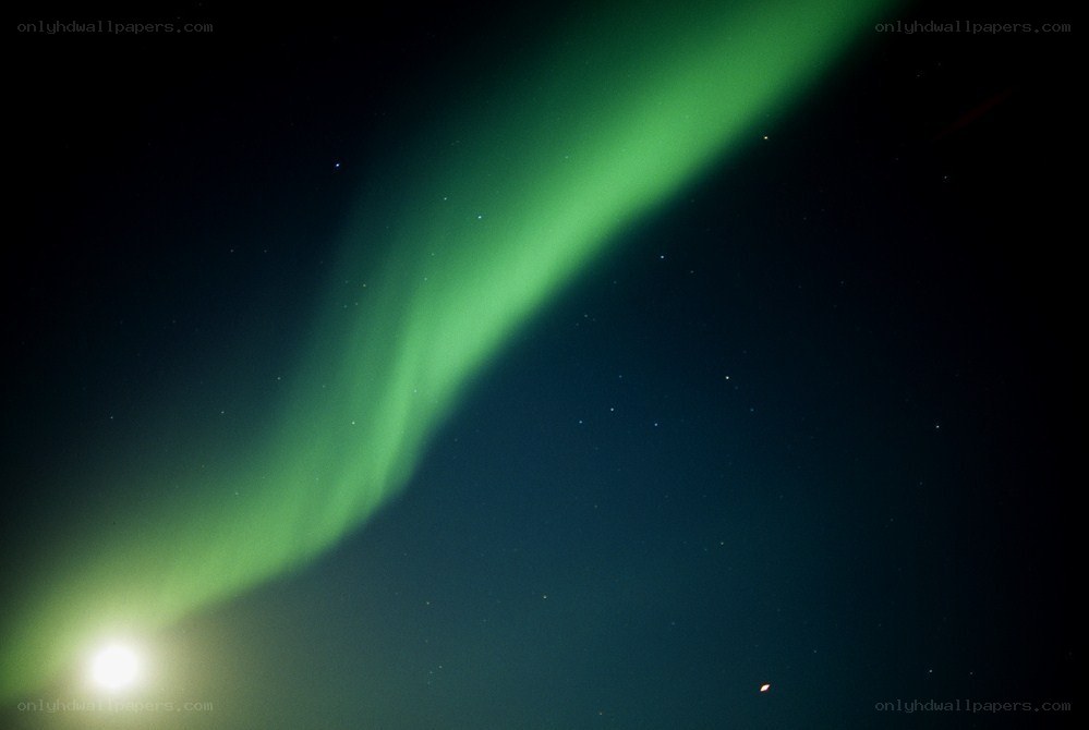 Green aurora in night sky
