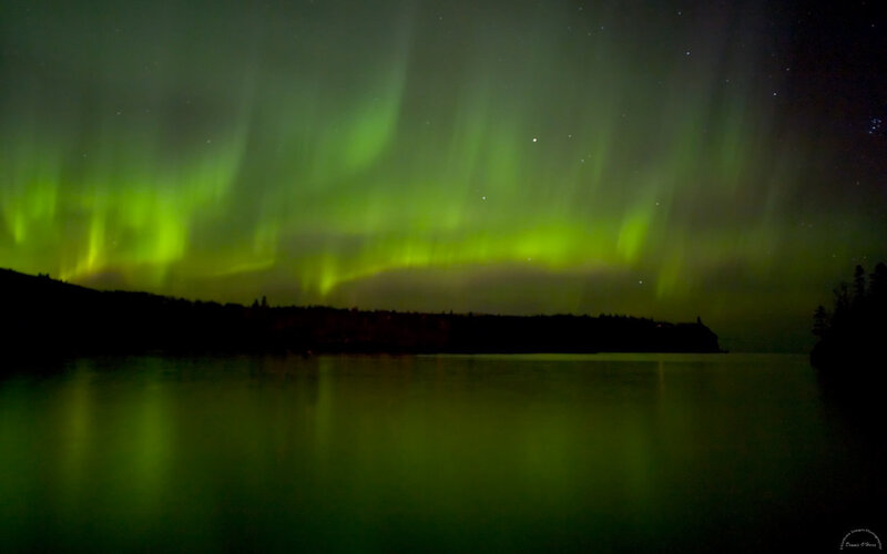 Green aurora over a lake
