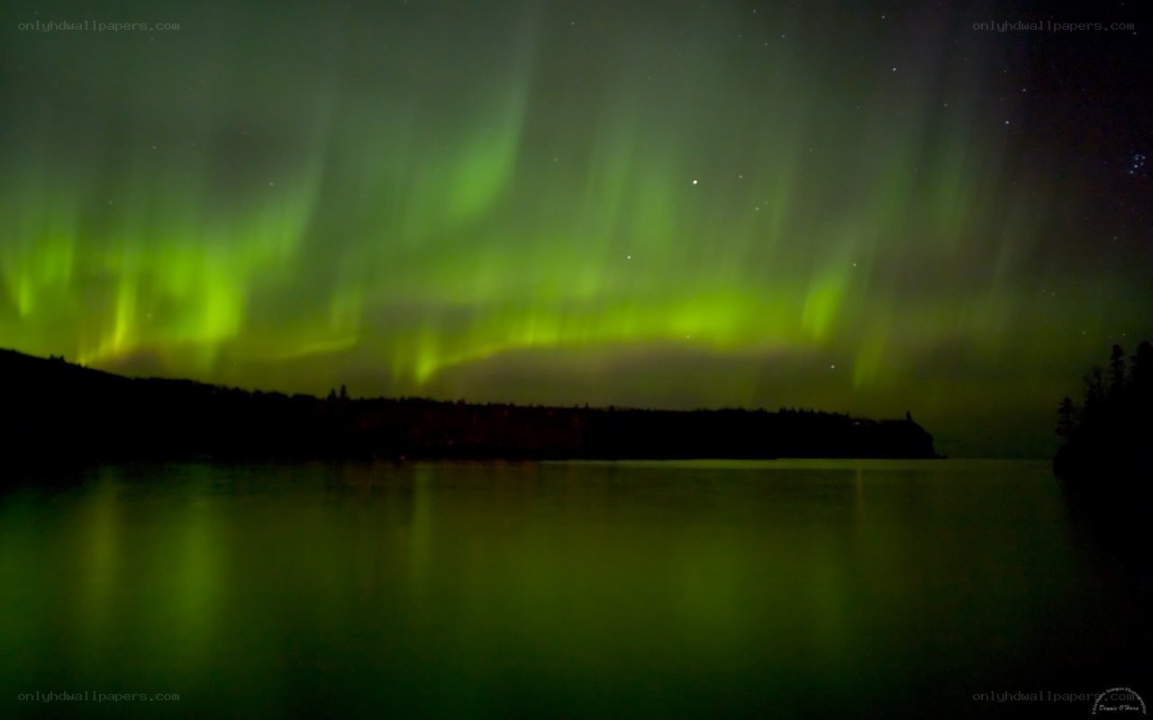 Green aurora over a lake