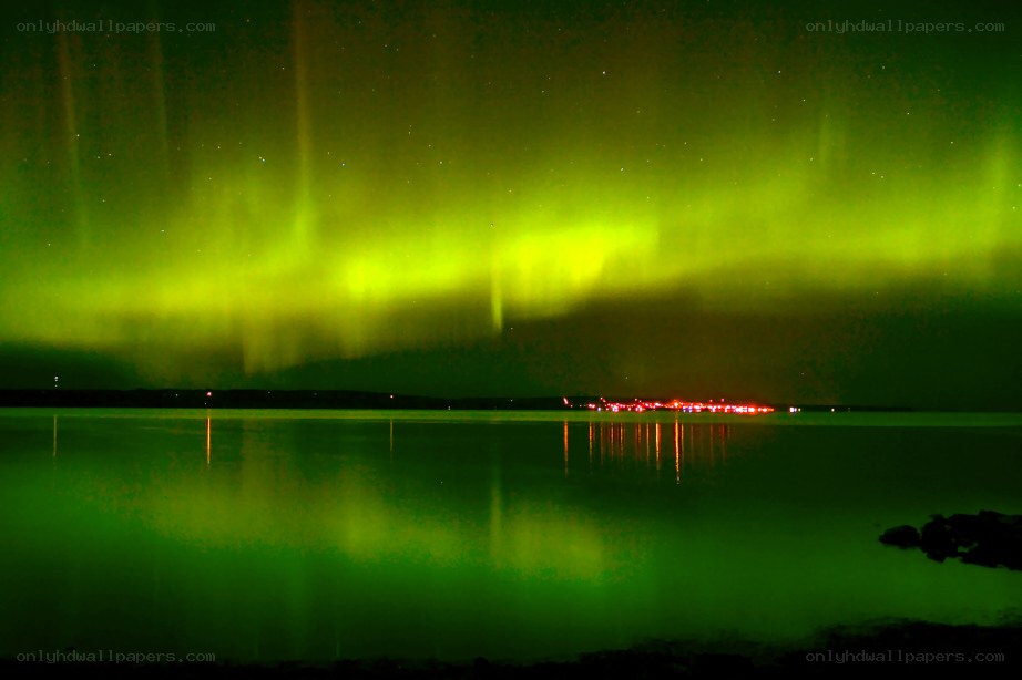 Green aurora over a lake