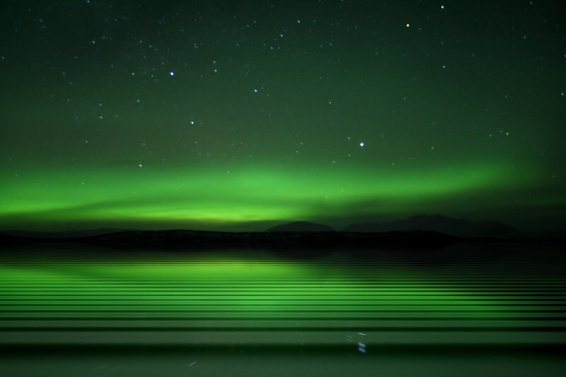 Green aurora over a lake