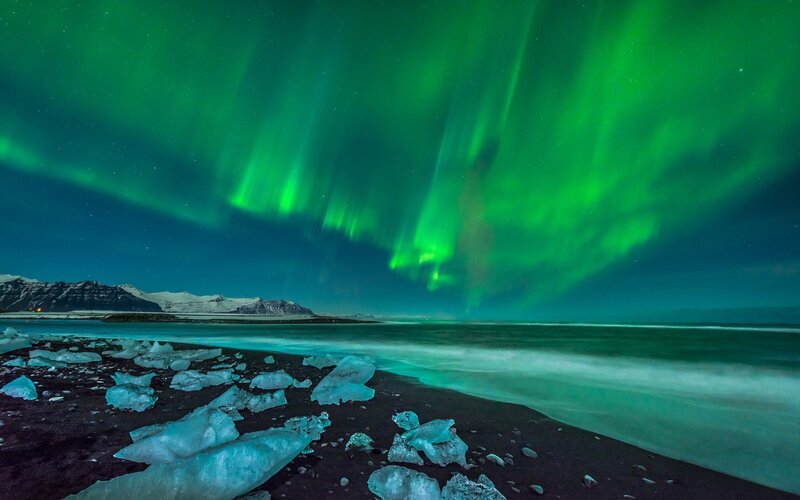 Green Aurora over Ice Beach — Dramatic