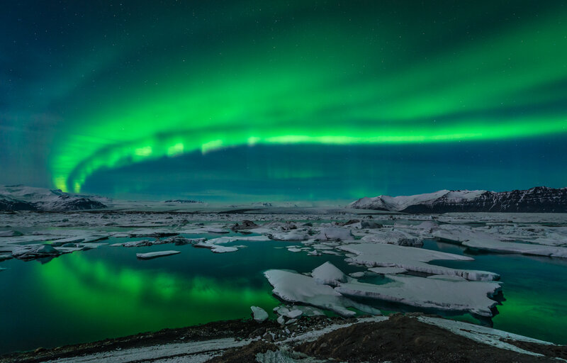 Green Aurora over Icebergs — Dramatic