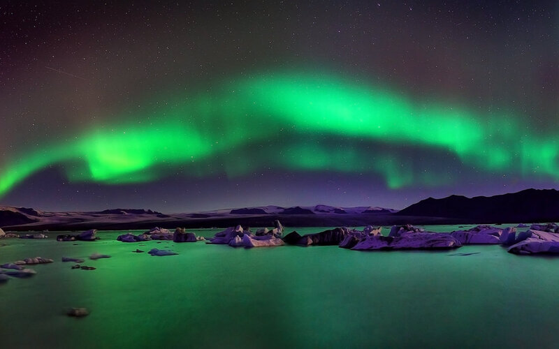 Green Aurora over Icebergs