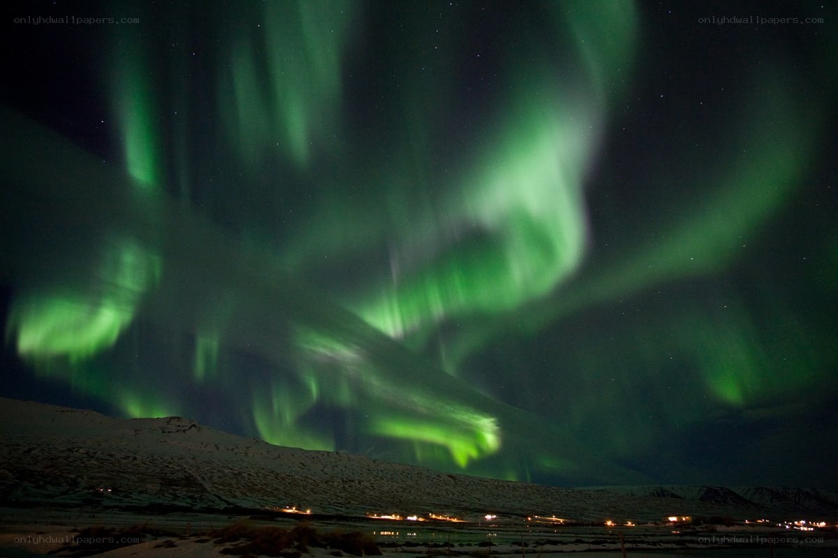 Green aurora over snowy landscape