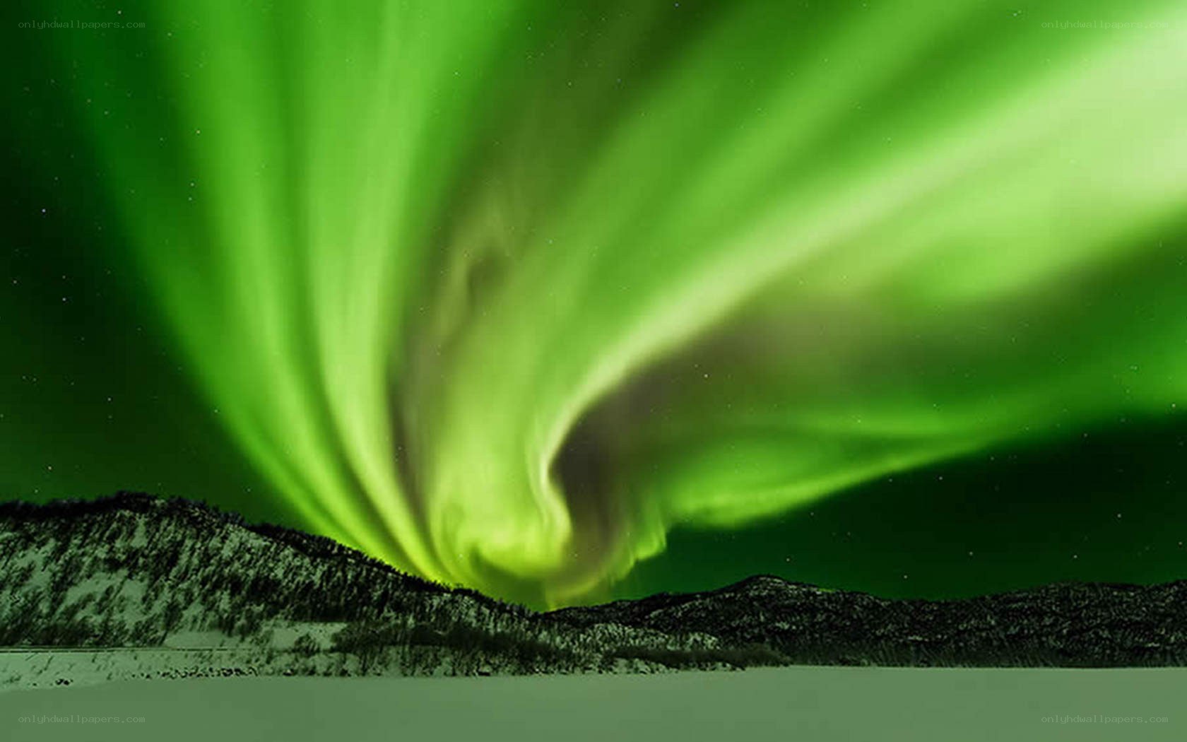 Green aurora over snowy mountains