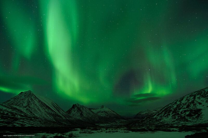 Green aurora over snowy mountains