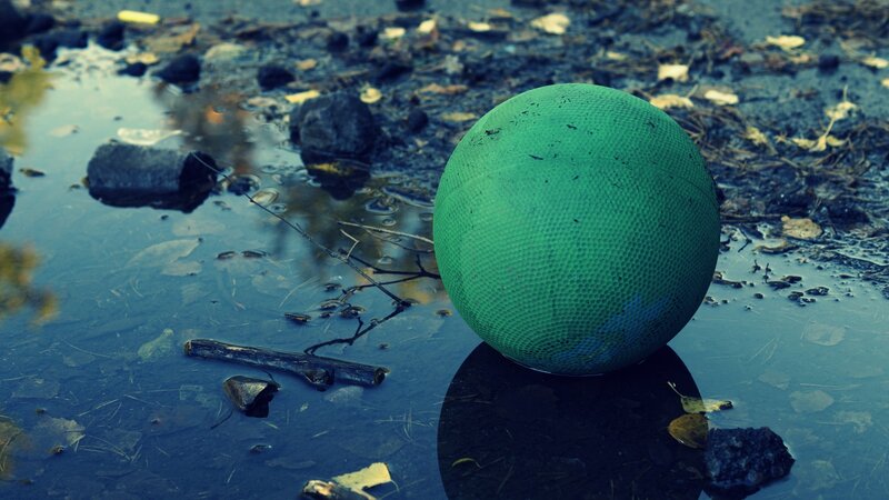 Green ball in a puddle