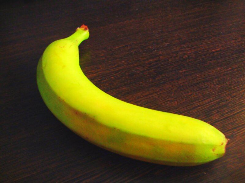 green banana on wooden surface