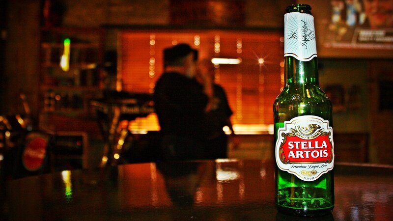 Green Beer Bottle on Table