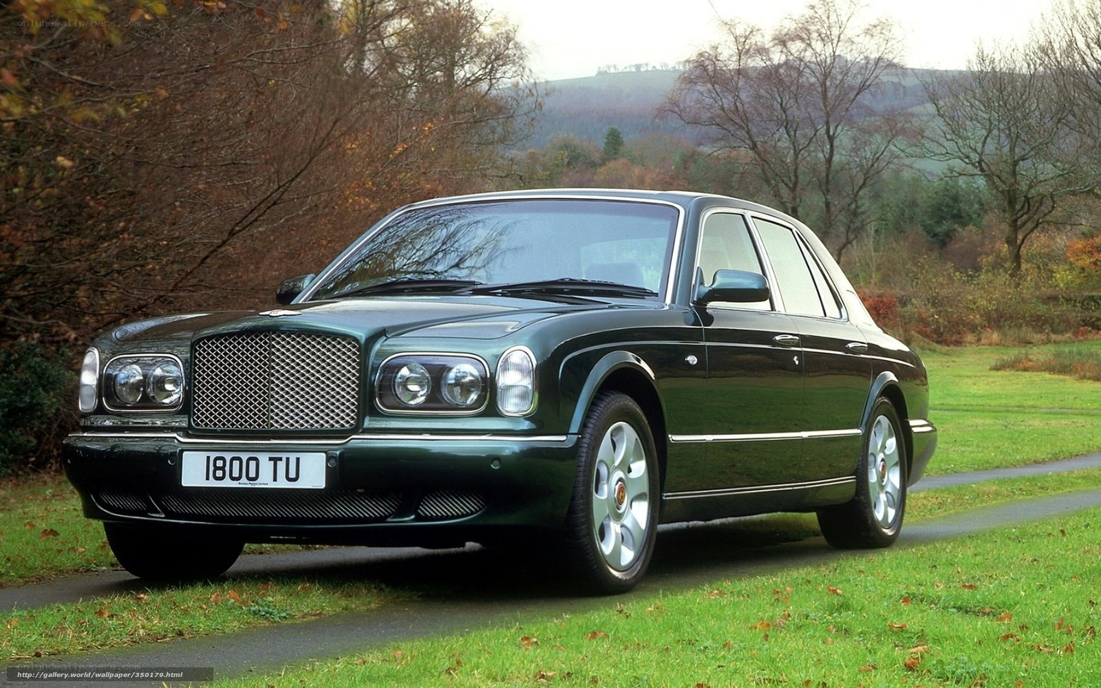 Green Bentley parked on a path