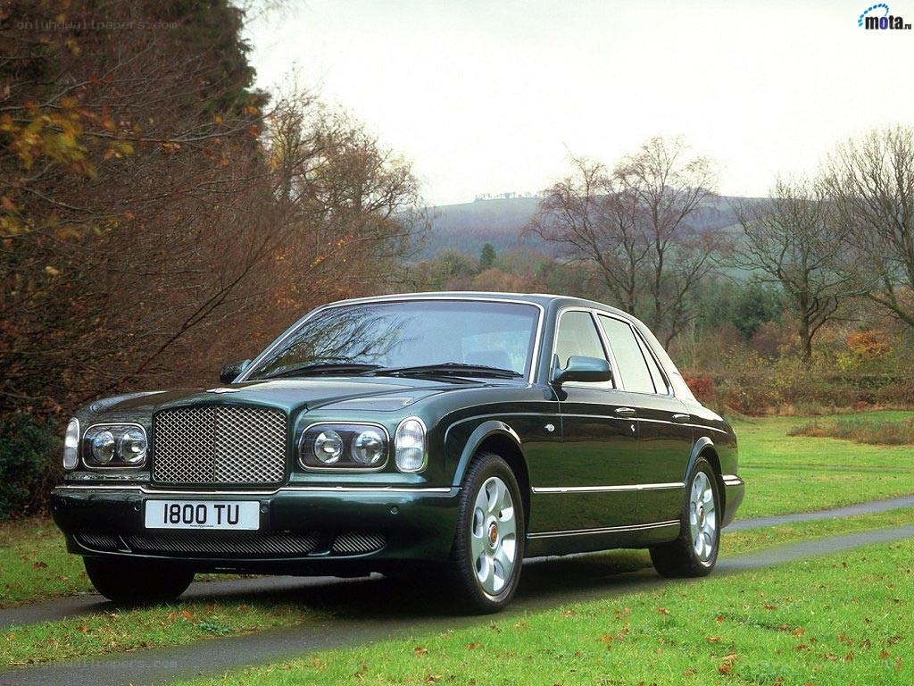 green bentley parked on road
