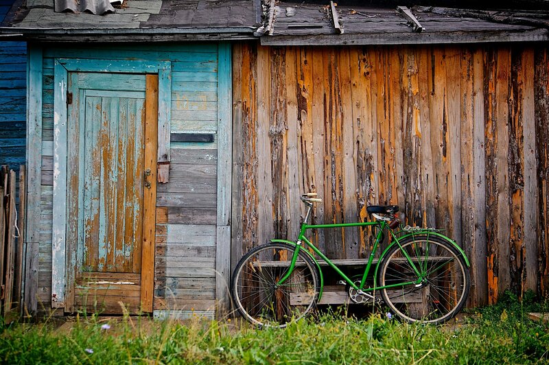 Green Bicycle Against Shed