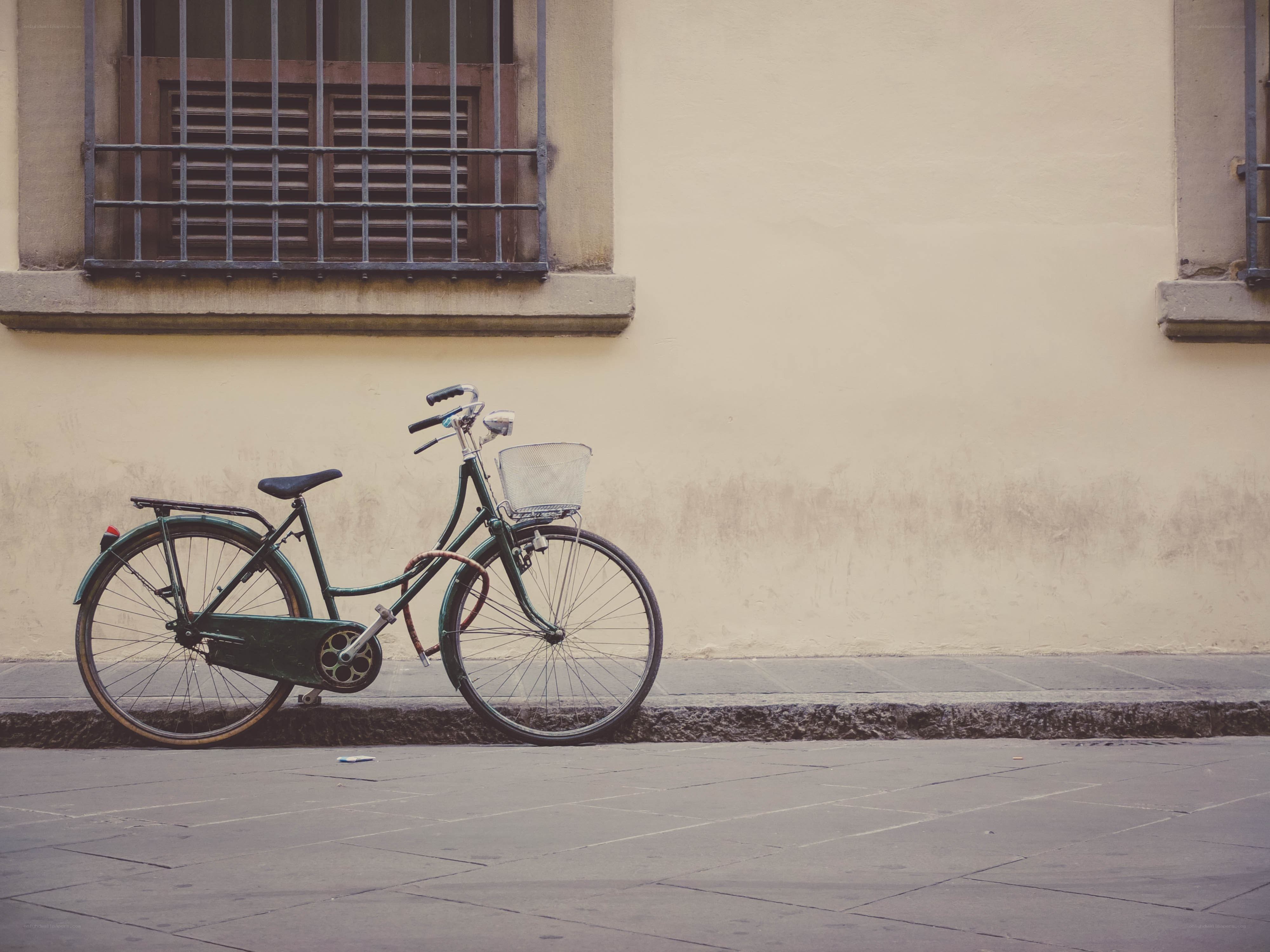 green bicycle by wall