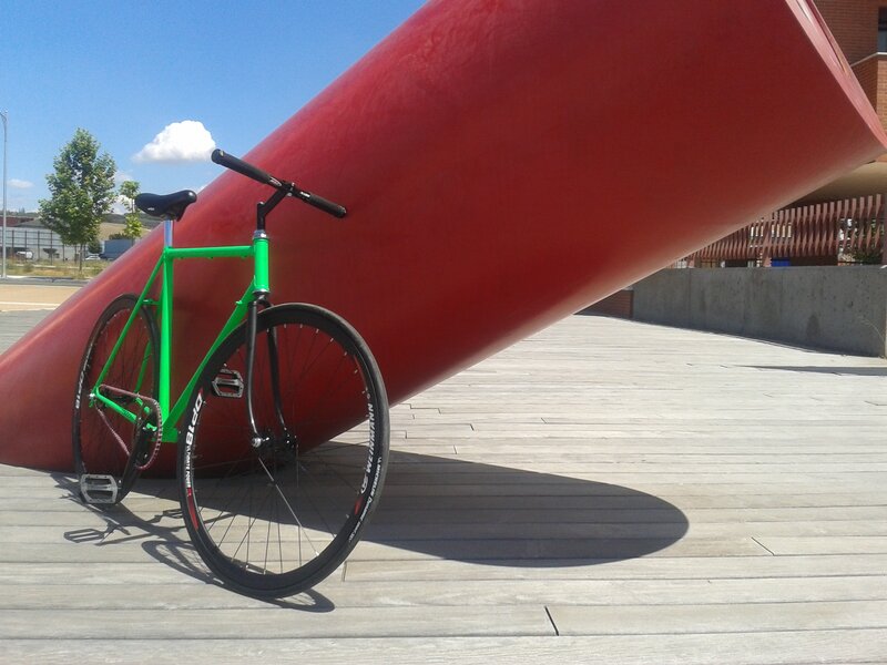 green bicycle near red sculpture