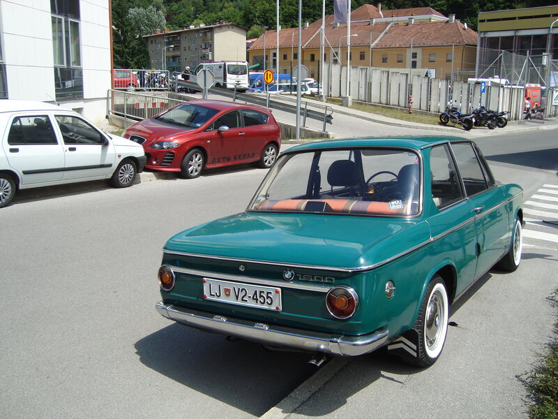 Green BMW 1600 on a city street